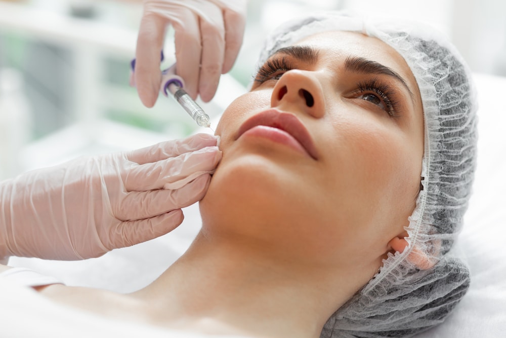 Face of a nice adult woman during Xeomin injection